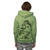 Back of model wearing the heather Green Unisex Hoodie with Japanese pine tree screen print design.